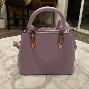 Adorable lavender mini handbag.